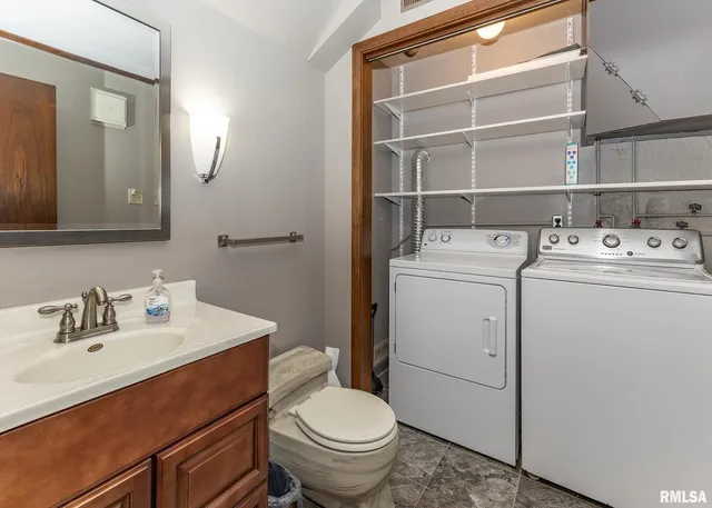 a bathroom with a sink toilet and a mirror