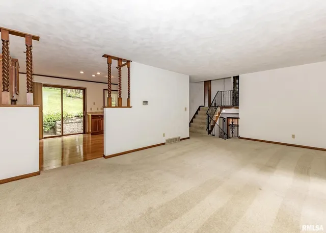 a view of a livingroom with furniture and an empty room