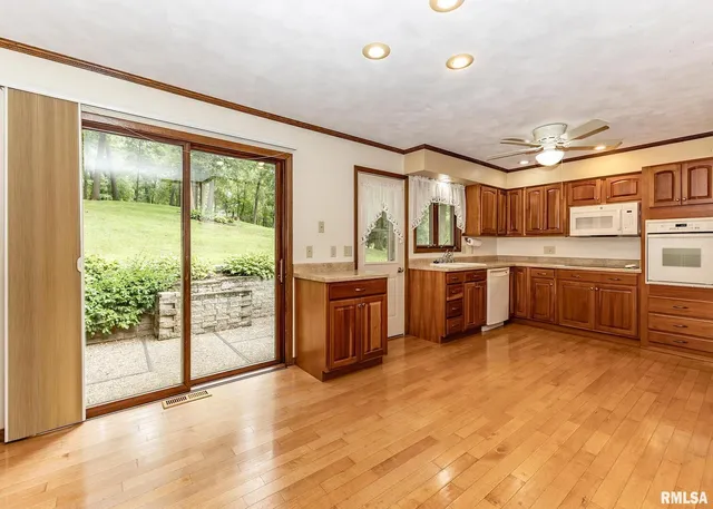 a kitchen with stainless steel appliances granite countertop a stove and cabinets