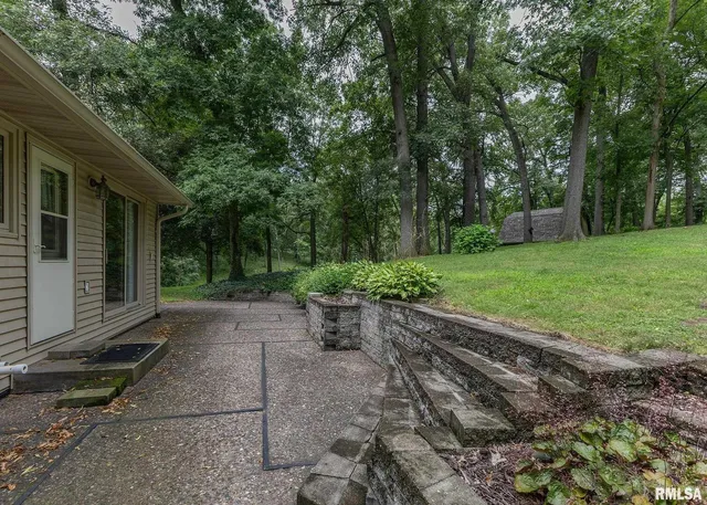 a view of a backyard with sitting area