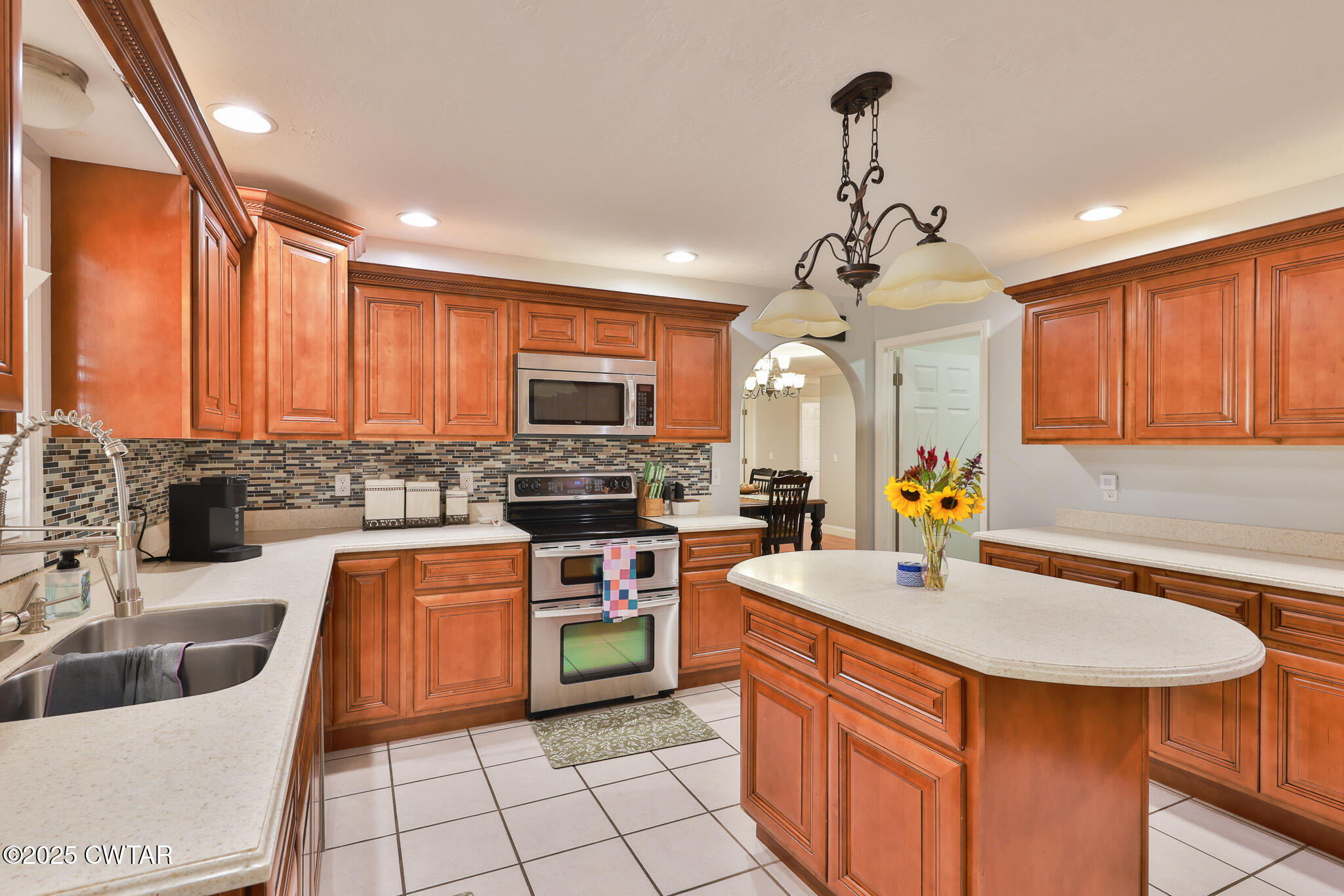 141 Oak Street Martin, TN 38237 - Photo 17 of 30 a kitchen with stainless steel appliances granite countertop a sink a stove top oven a counter space and cabinets