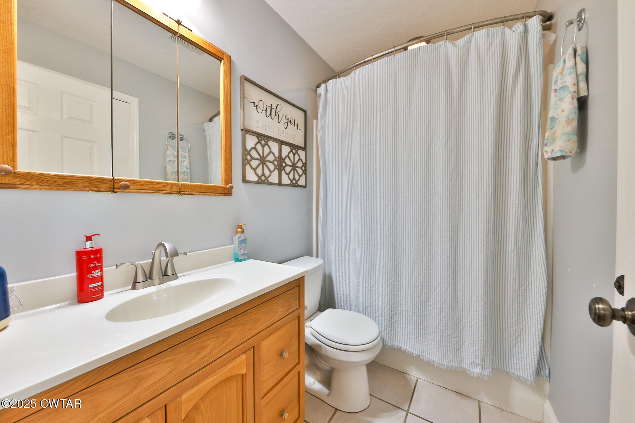 141 Oak Street Martin, TN 38237 - Photo 23 of 30 a bathroom with a sink a toilet and a shower