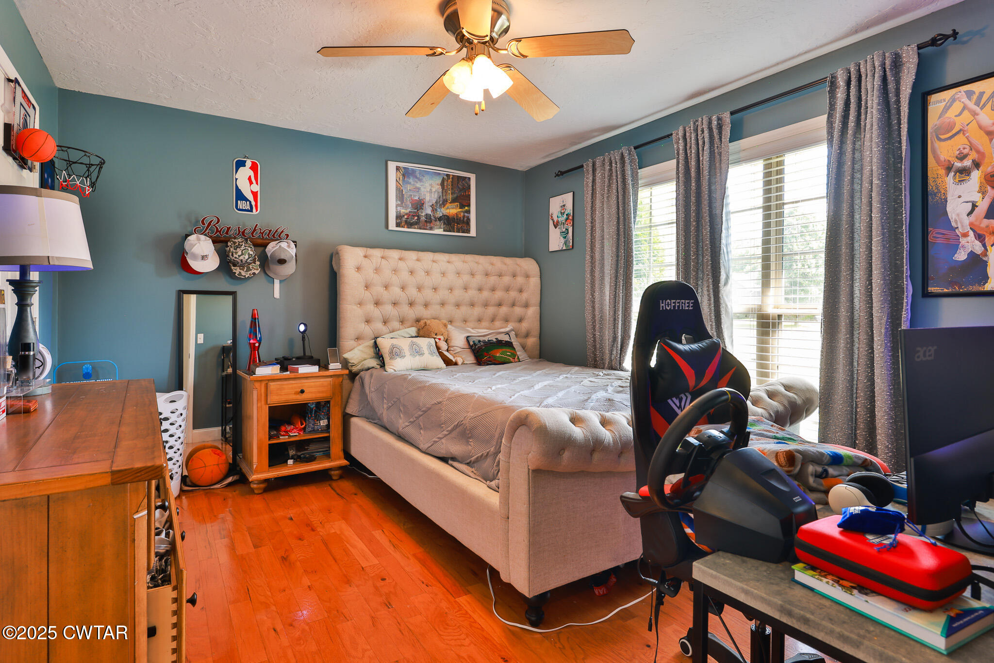 141 Oak Street Martin, TN 38237 - Photo 24 of 30 a bedroom with a bed and a chandelier