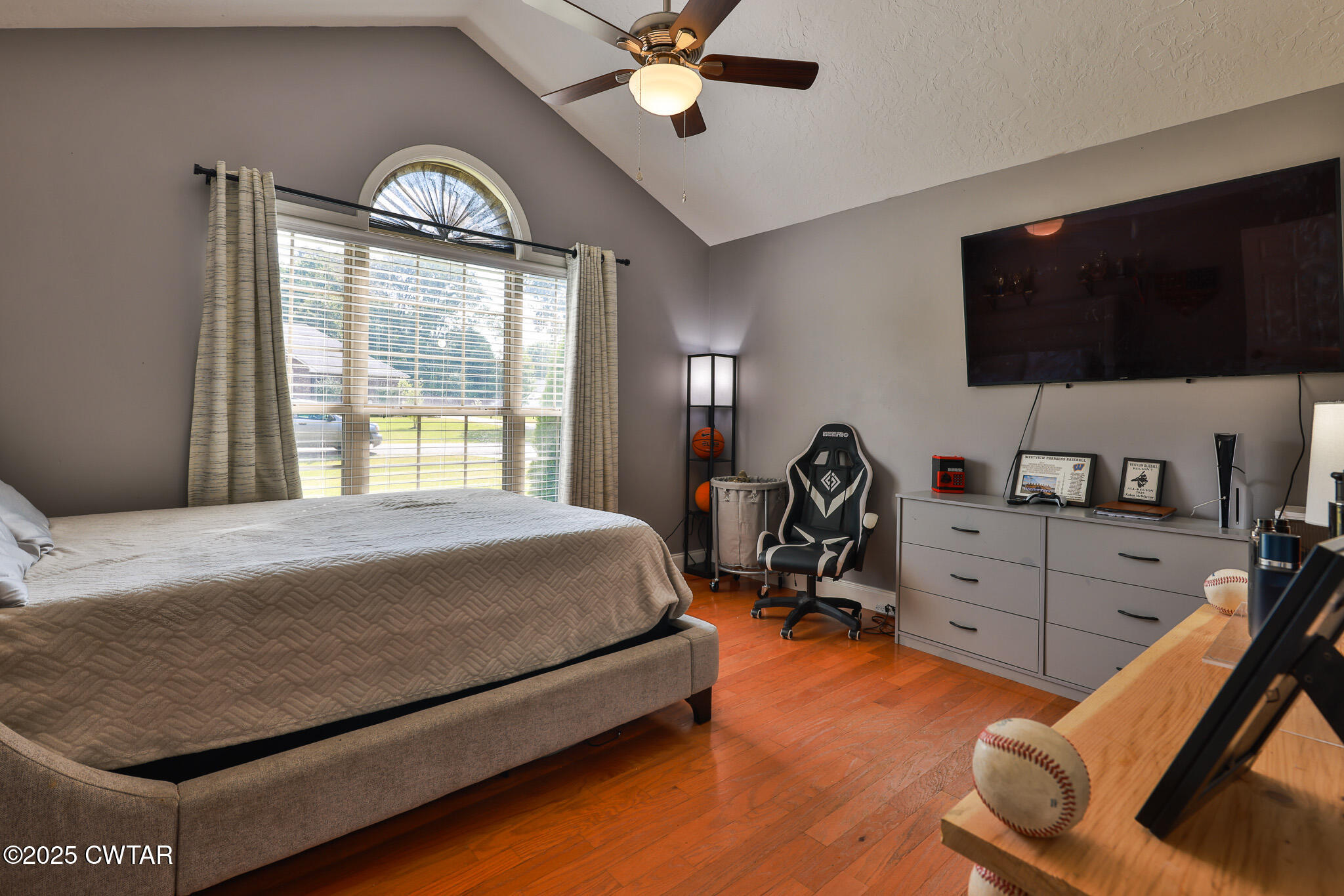 141 Oak Street Martin, TN 38237 - Photo 25 of 30 a bedroom with a bed and a flat screen tv