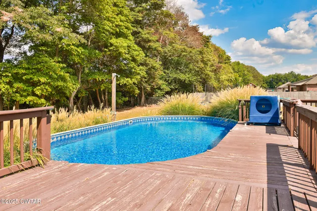 a view of a swimming pool with a patio