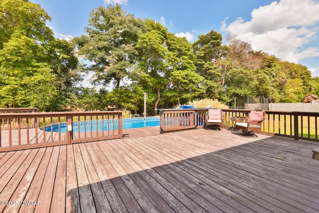 a balcony with wooden floor and fence
