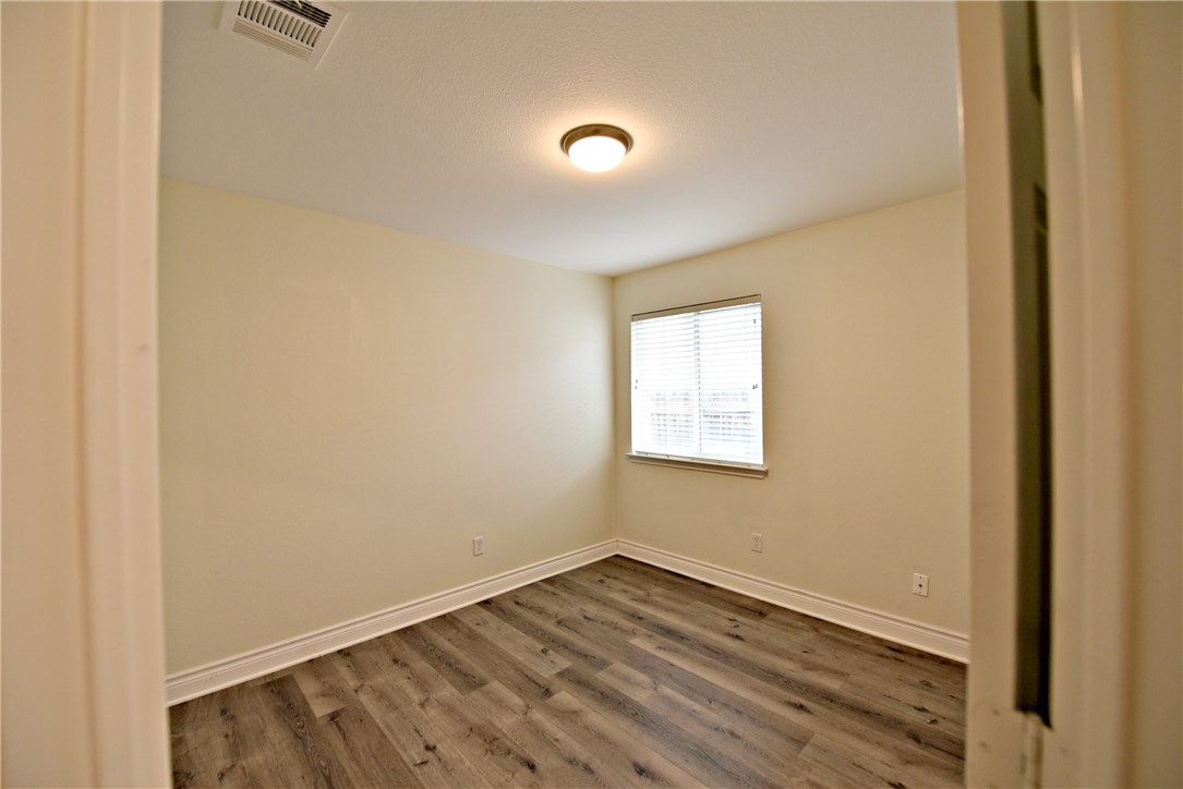 3665 Spring Canyon Trail Round Rock, TX 78681 - Photo 16 of 21 a view of an empty room with wooden floor and a window