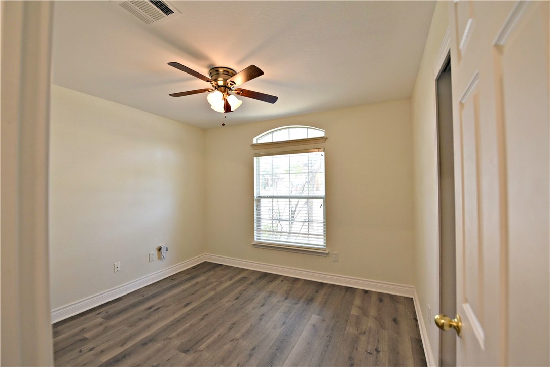 3665 Spring Canyon Trail Round Rock, TX 78681 - Photo 17 of 21 a view of empty room with wooden floor and fan