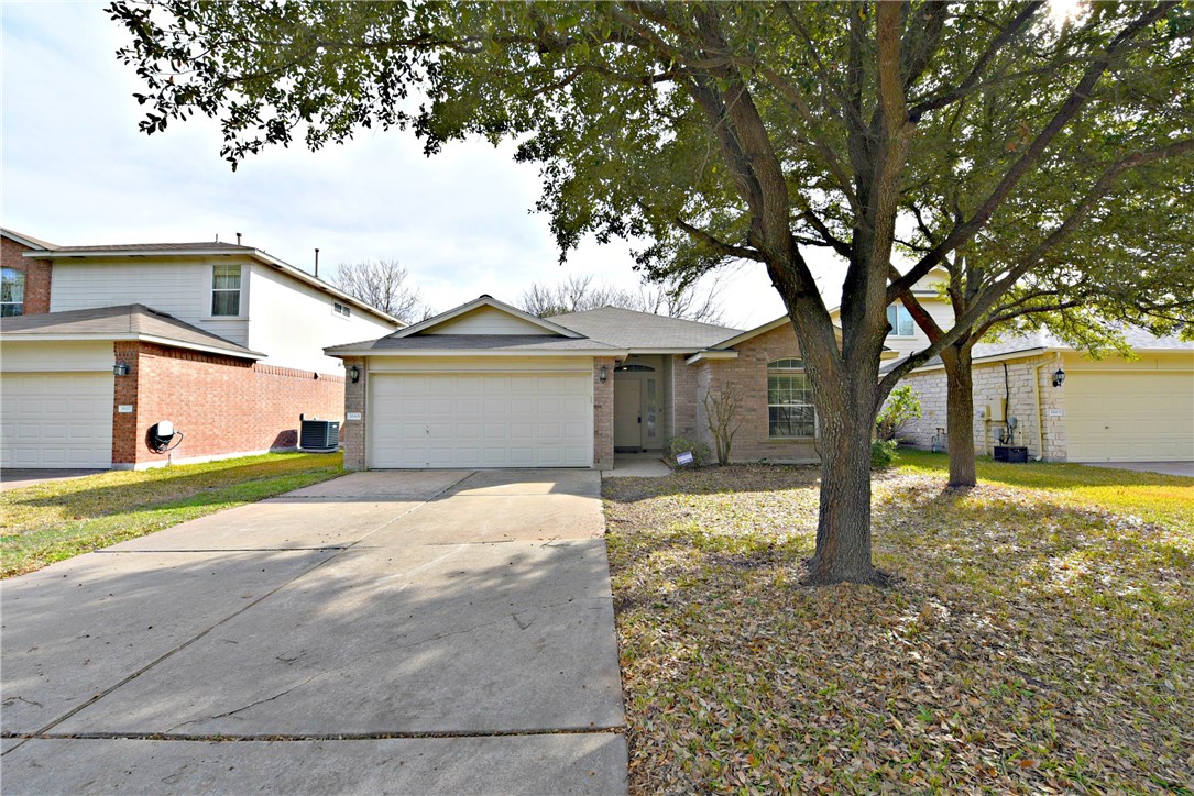 3665 Spring Canyon Trail Round Rock, TX 78681 - Photo 2 of 21 a front view of a house with a yard and garage