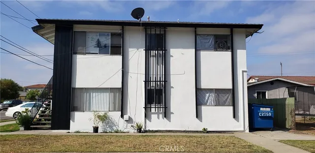 a view of a house with a porch and furniture