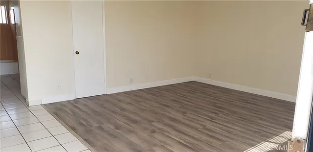 a view of a room with wooden floor