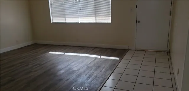 an empty room with wooden floor