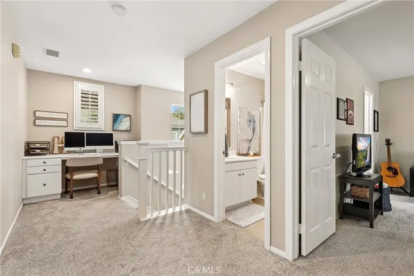 a view of a bedroom with furniture and windows