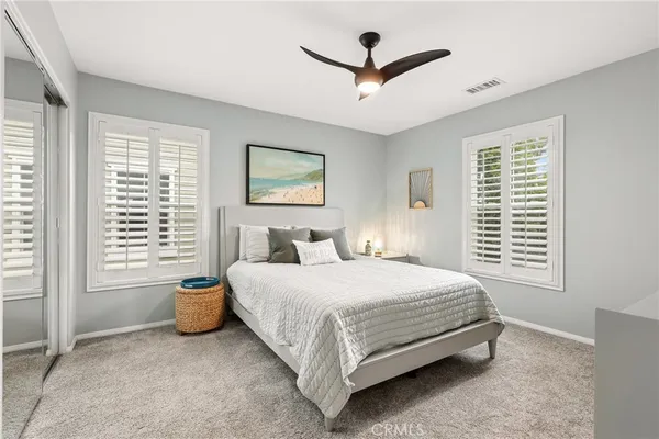 a bedroom with a bed a window and a walk in closet