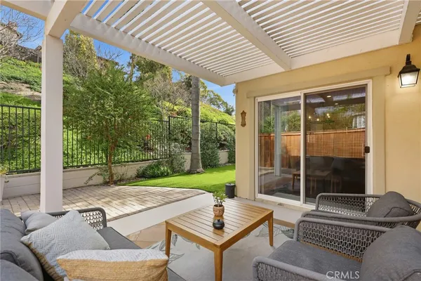 a view of a house with backyard sitting area and porch