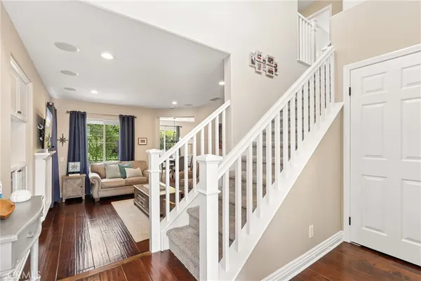 a view of entryway and hall with wooden floor