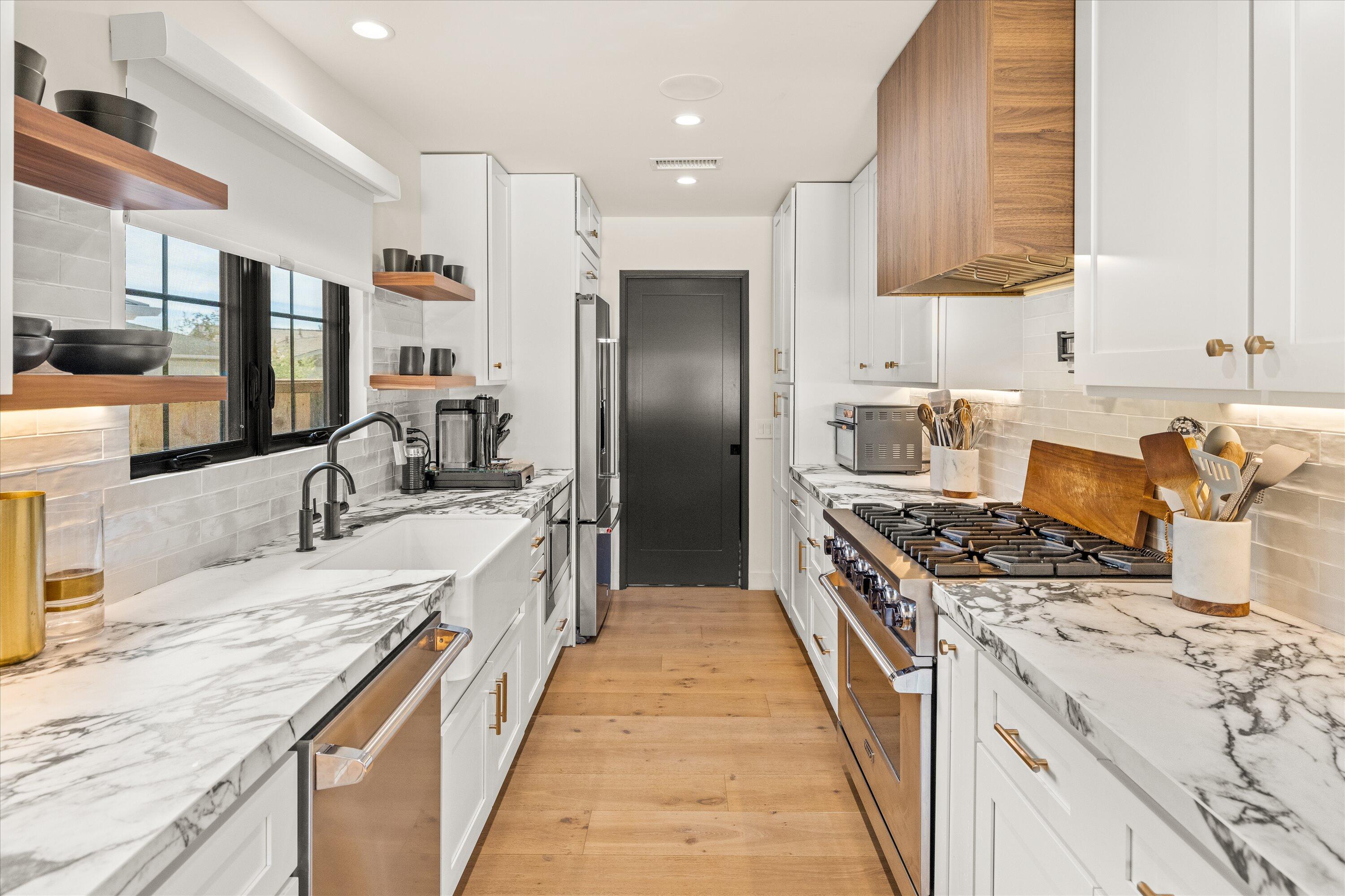 516 Mills Way Goleta, CA 93117 - Photo 12 of 38 a large kitchen with stainless steel appliances granite countertop a lot of counter space and wooden floors