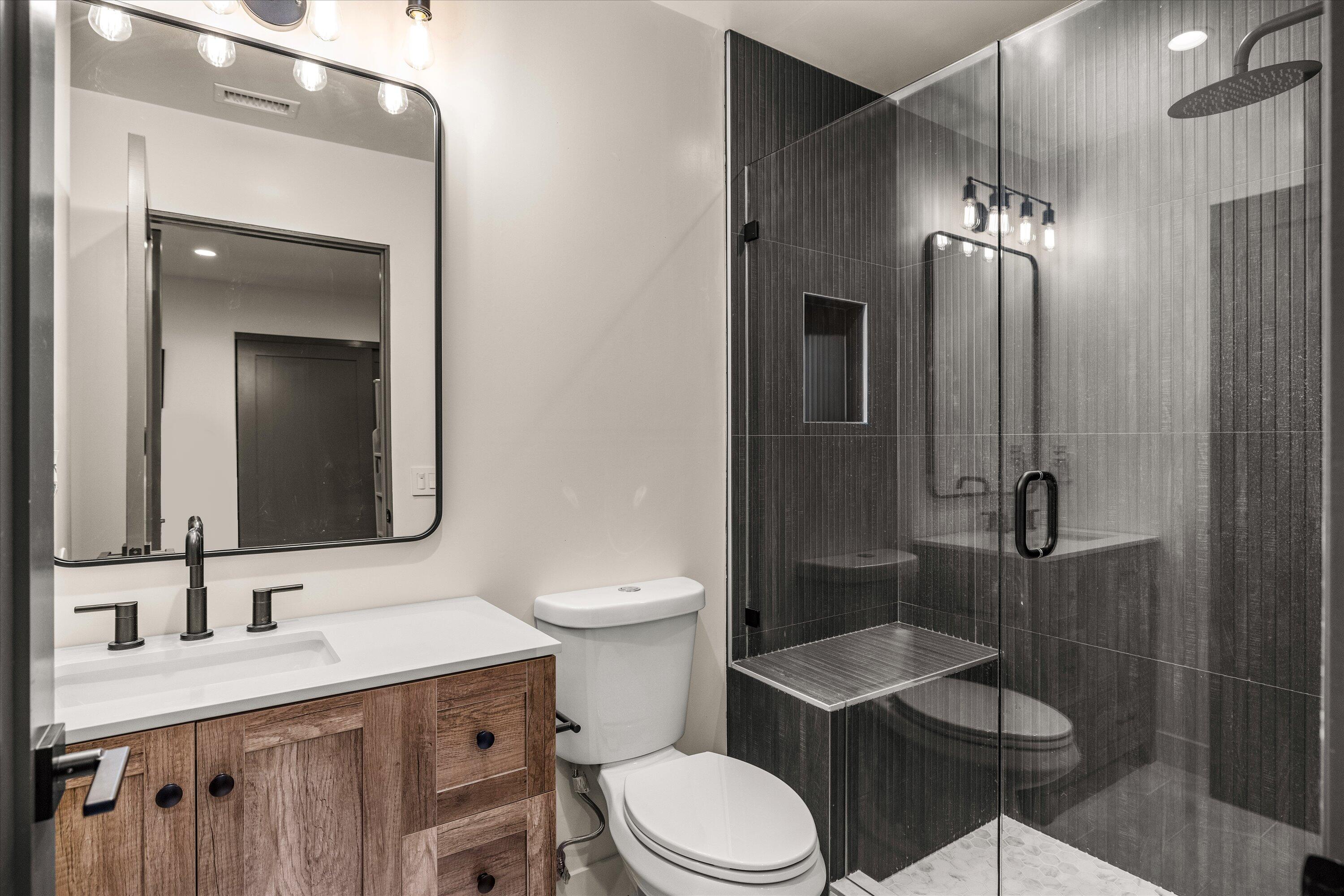 516 Mills Way Goleta, CA 93117 - Photo 25 of 38 a bathroom with a toilet a sink a shower and mirror