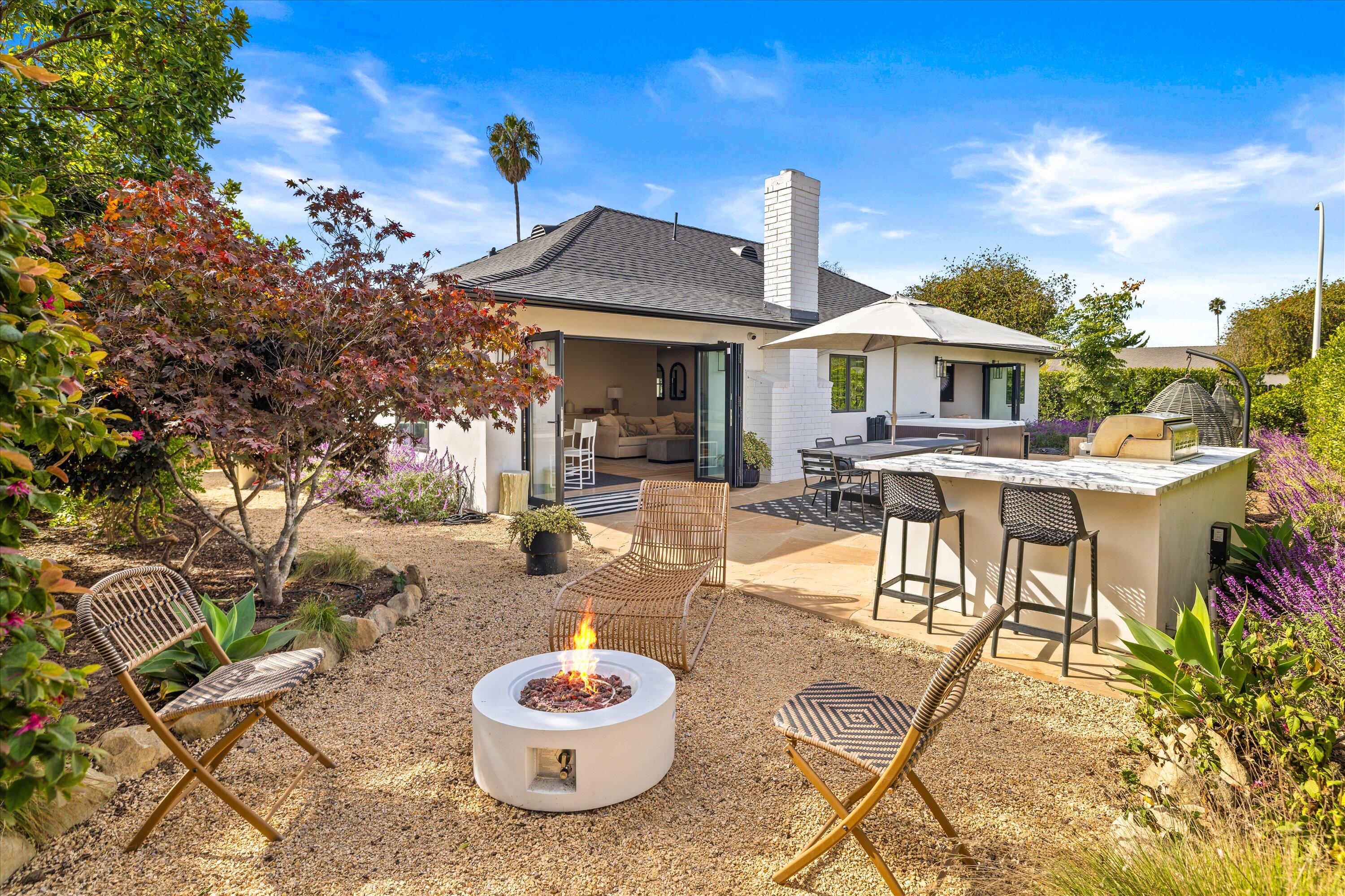 516 Mills Way Goleta, CA 93117 - Photo 32 of 38 a view of a patio with a table and chairs and potted plants