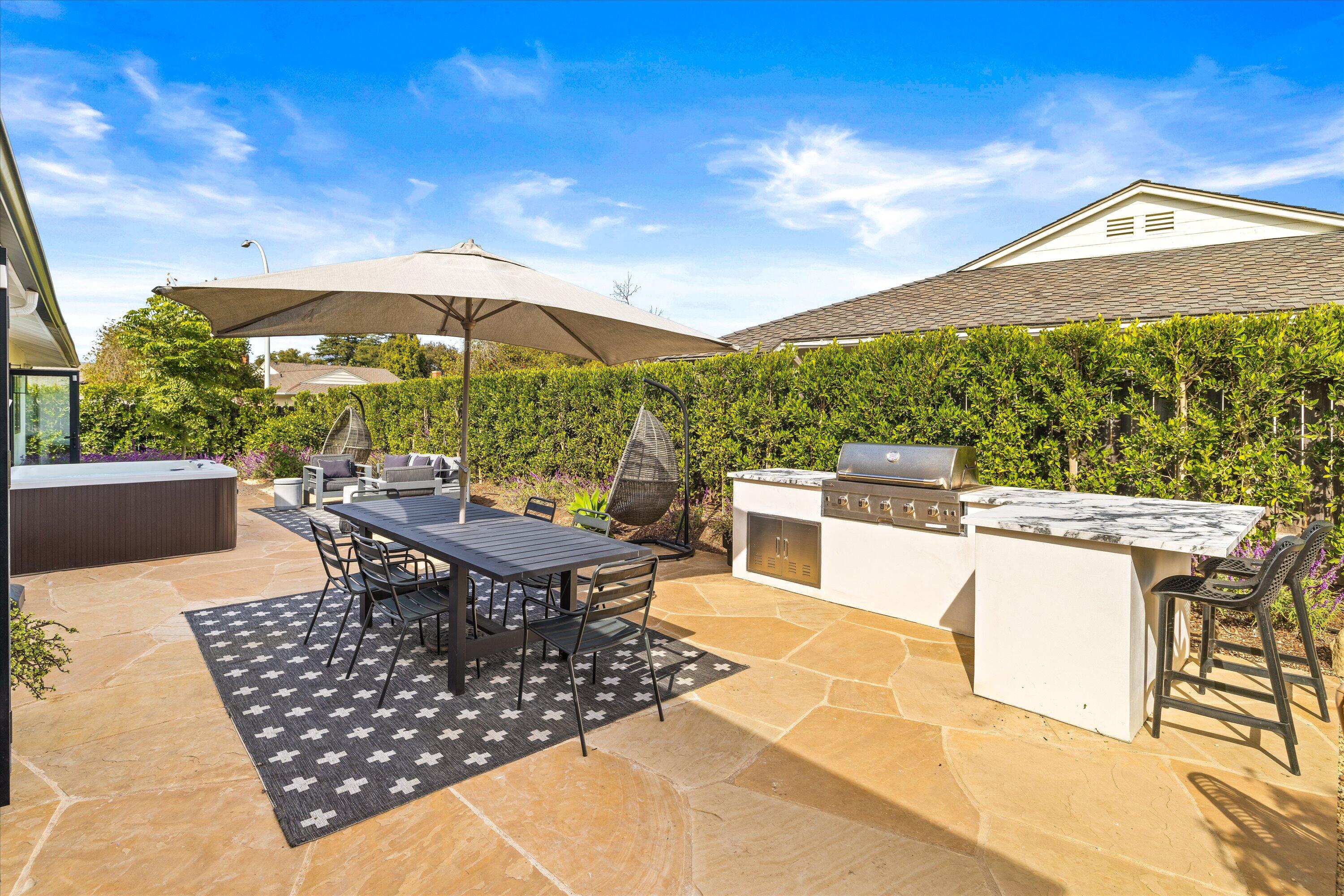 516 Mills Way Goleta, CA 93117 - Photo 34 of 38 a view of a roof deck with table and chairs under an umbrella
