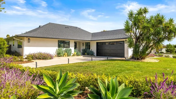 a front view of a house with garden