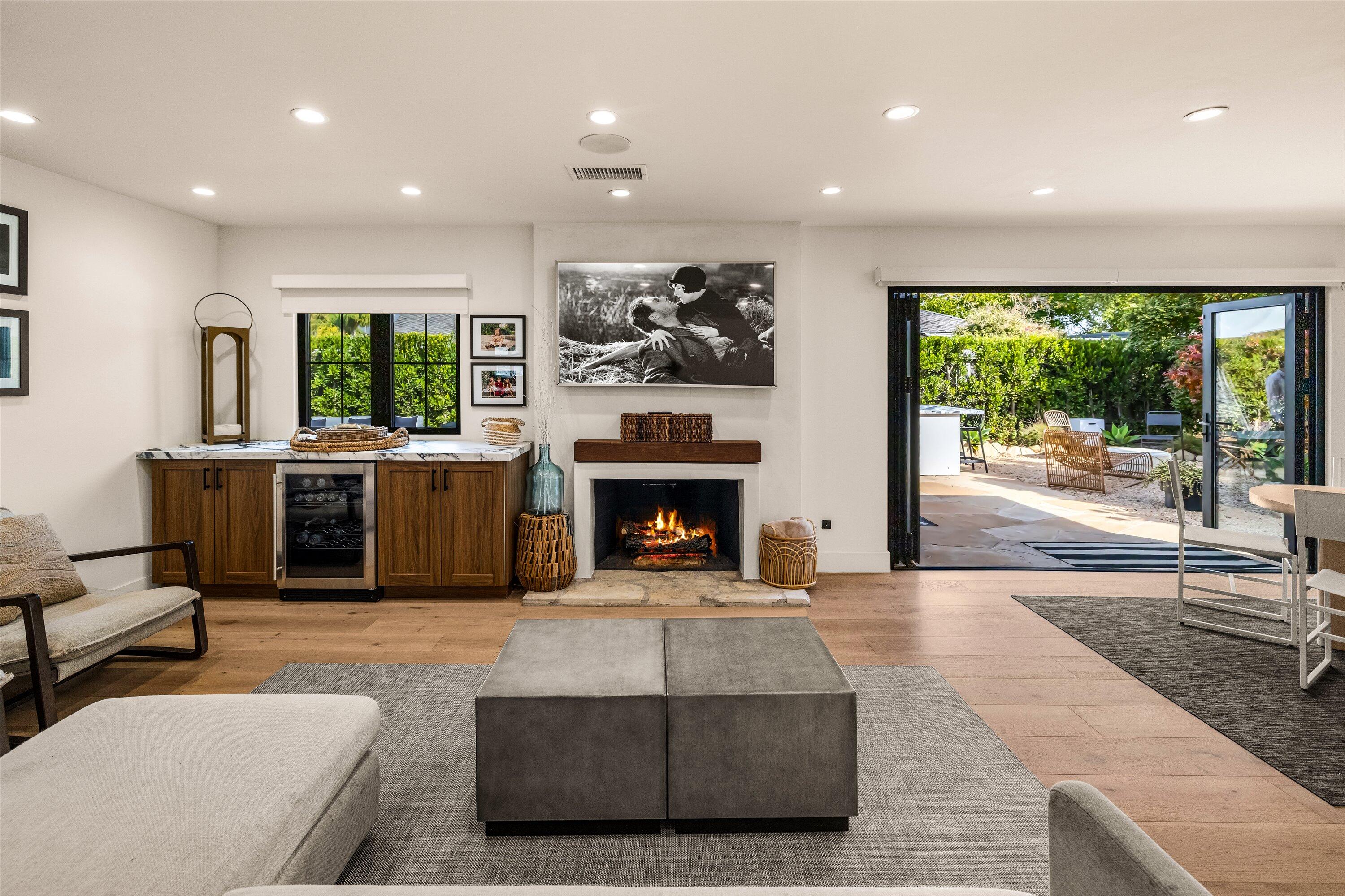 516 Mills Way Goleta, CA 93117 - Photo 5 of 38 a living room with furniture a fireplace and a floor to ceiling window