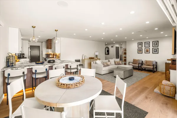 a living room with furniture and a dining table with kitchen view