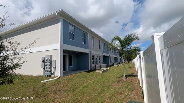 a view of yellow house with a tree
