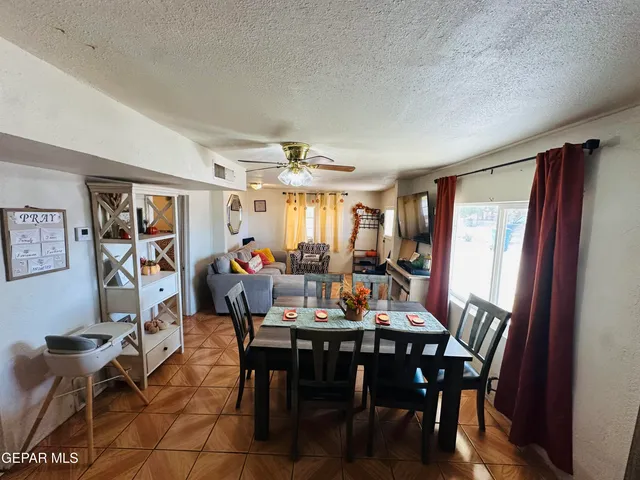a living room with a bed and a flat screen tv