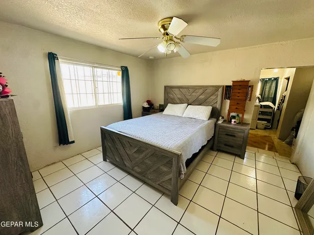 a bedroom with stainless steel appliances a rug and a window