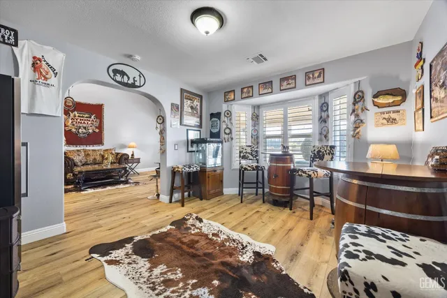 a bedroom with furniture and a wooden floor