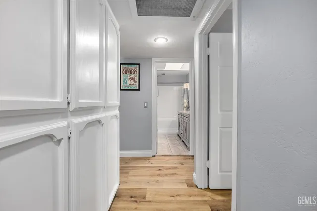 a view of a hallway with wooden floor and entryway