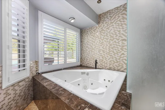 a bathroom with a bathtub and a shower