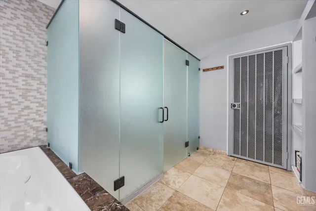 a bathroom with a tub and shower