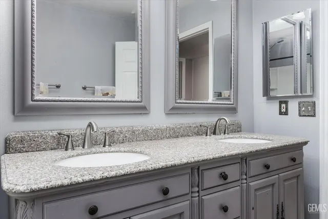 a bathroom with sink granite and mirror
