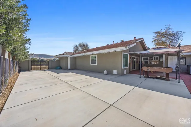 a view of a patio with wooden floor and a yard