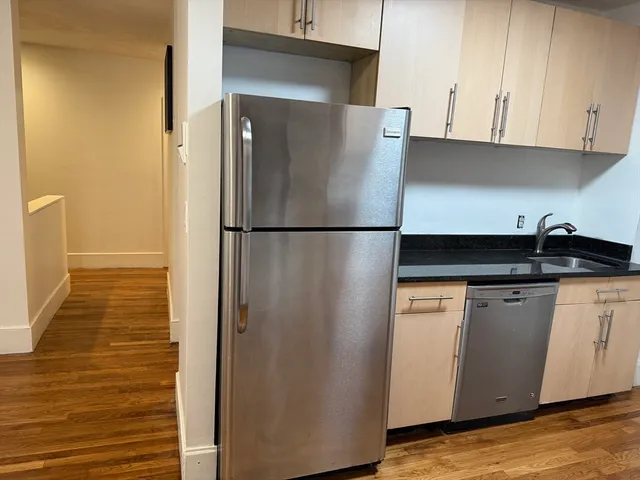 a kitchen with stainless steel appliances a stove a microwave and sink