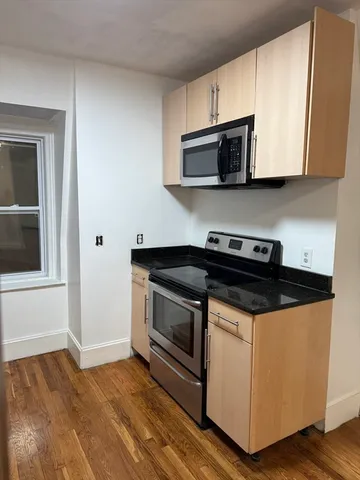 a room with wooden floor and white walls