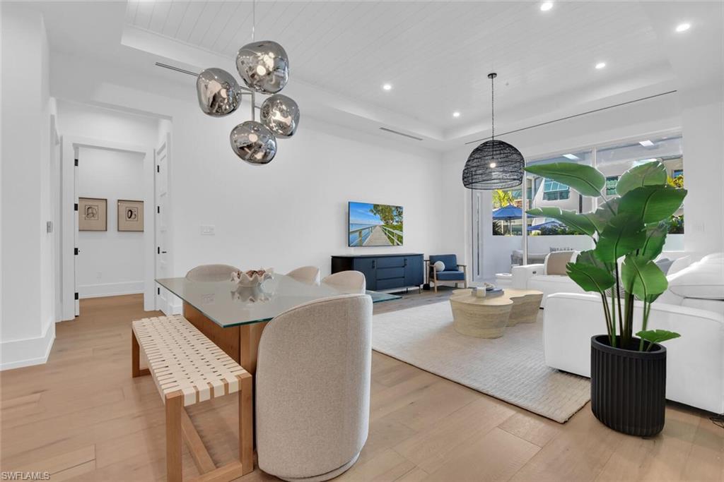 201 8th Street South, Unit 209 Naples, FL 34102 - Photo 13 of 41 a living room with furniture and a potted plant