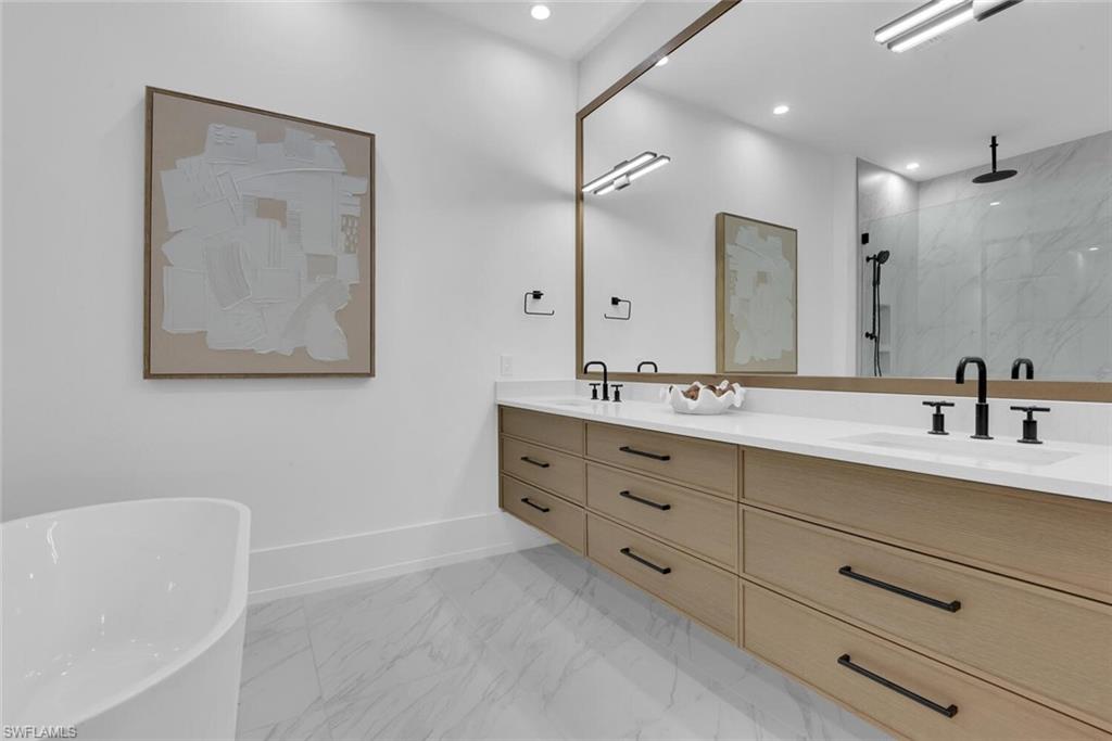201 8th Street South, Unit 209 Naples, FL 34102 - Photo 16 of 41 a bathroom with a double vanity sink mirror and bathtub