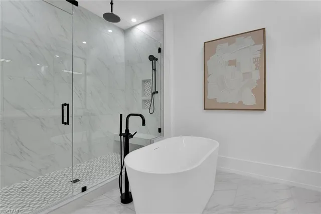 a white bath tub sitting next to a bathroom