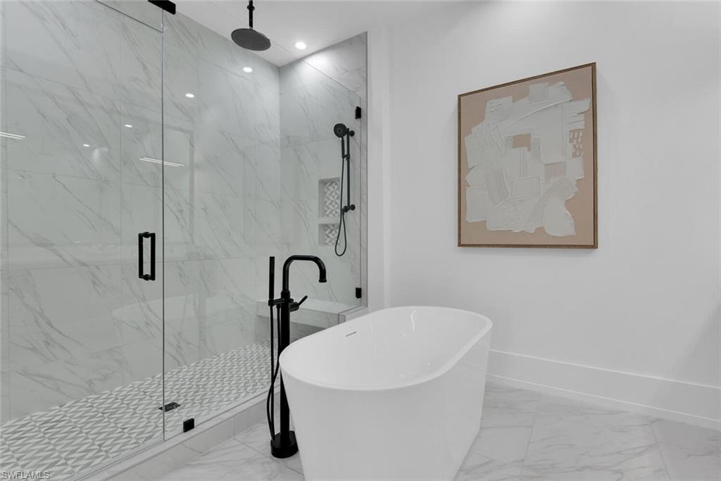 201 8th Street South, Unit 209 Naples, FL 34102 - Photo 17 of 41 a white bath tub sitting next to a bathroom