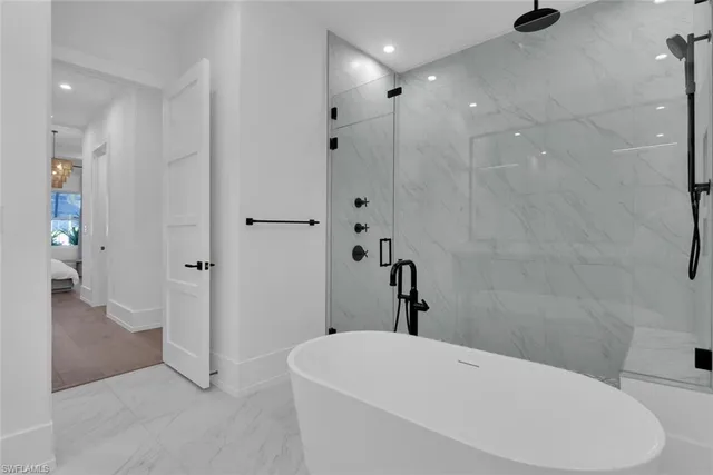 a bathroom with a bathtub and shower