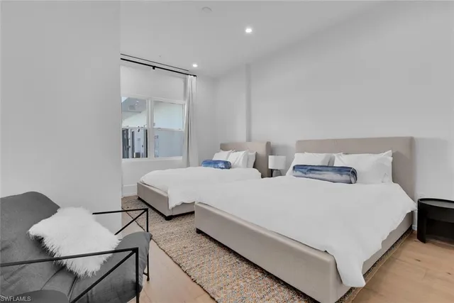 a bedroom with a bed and white cabinets