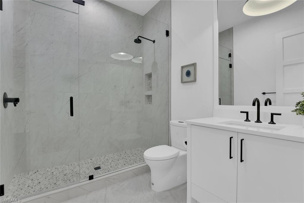 201 8th Street South, Unit 209 Naples, FL 34102 - Photo 21 of 41 a bathroom with a sink a toilet and shower