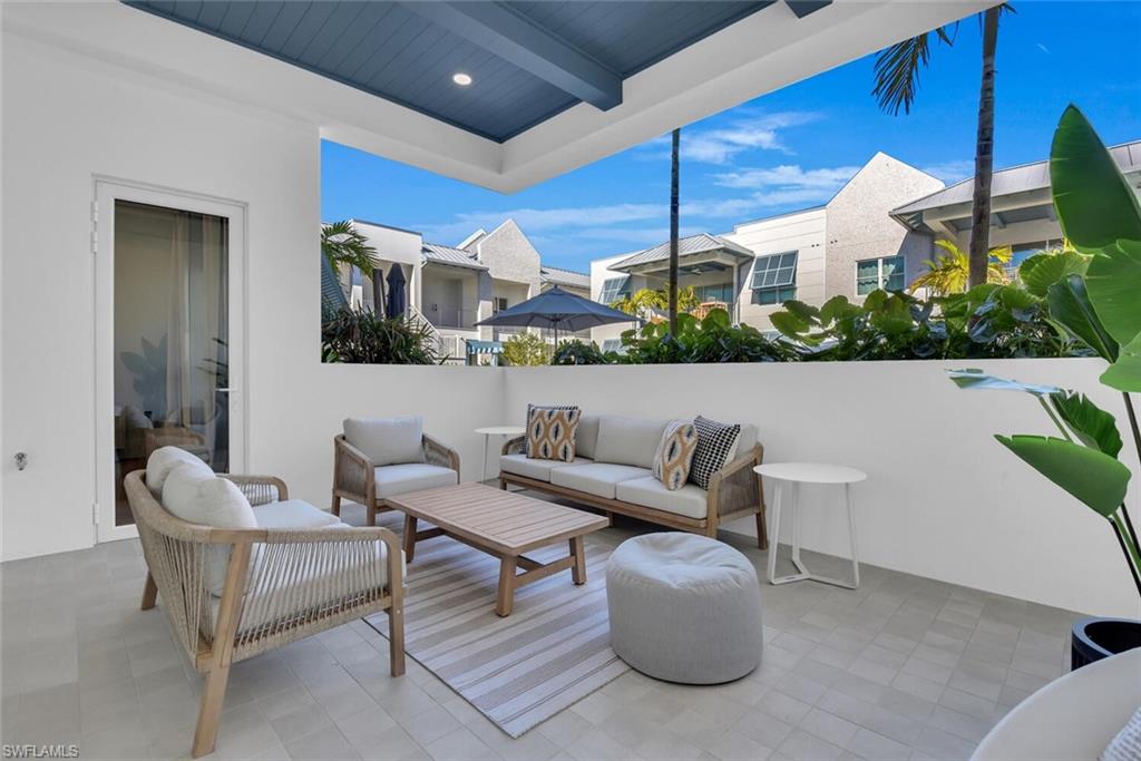 201 8th Street South, Unit 209 Naples, FL 34102 - Photo 23 of 41 a outdoor living space with furniture and city view