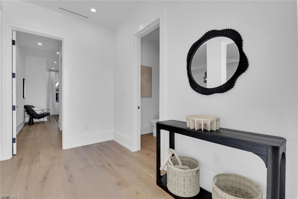 201 8th Street South, Unit 209 Naples, FL 34102 - Photo 3 of 41 a bathroom with a toilet a sink and a mirror