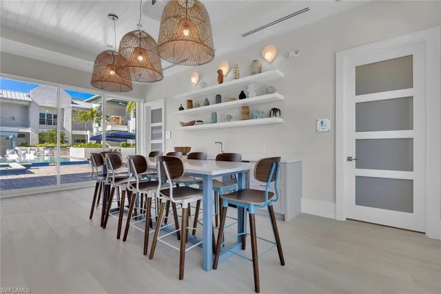 a view of a dining room with furniture and chandelier