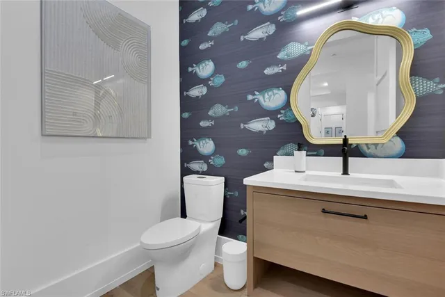 a bathroom with a toilet sink and mirror