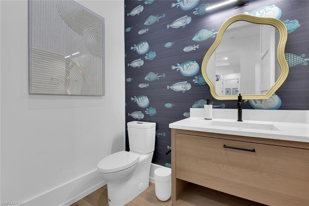 201 8th Street South, Unit 209 Naples, FL 34102 - Photo 4 of 41 a bathroom with a toilet sink and mirror